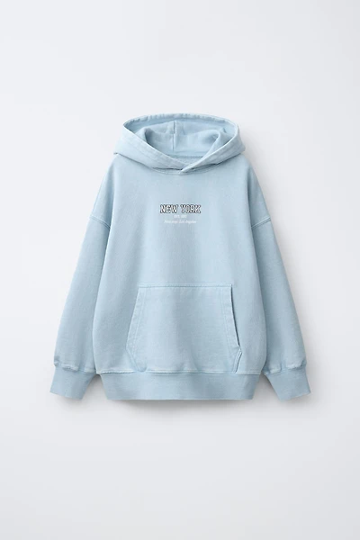 SWEAT À CAPUCHE EFFET DÉLAVÉ ET INSCRIPTION
