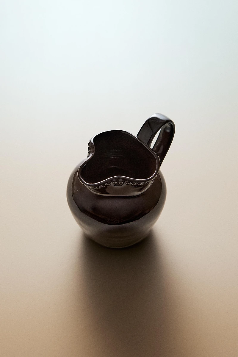 RAISED DESIGN STONEWARE JUG