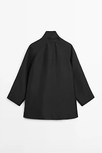 Flowing voluminous cape with button details
