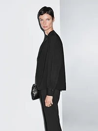 Blouse with crossover detail and button