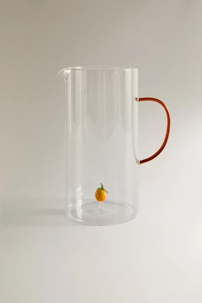 GLASS PITCHER WITH A HANDLE AND ORANGE DETAIL