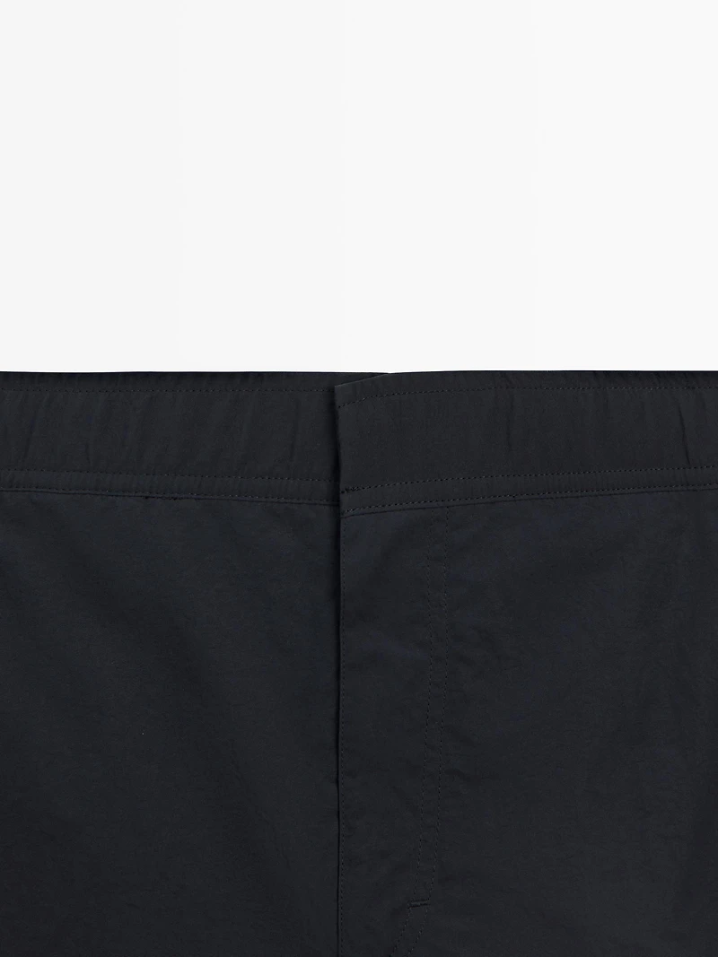 Plain swimming trunks with waist detail