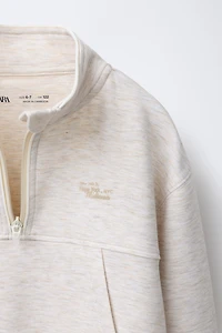 RAISED TEXT SWEATSHIRT