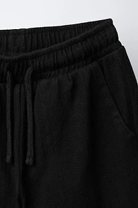 TEXTURED PANTS WITH LABEL