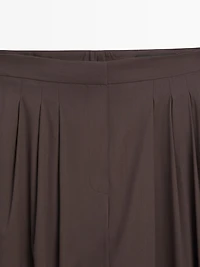 Wide-leg pleated trousers with side vents
