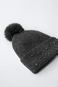 BONNET EN MAILLE BRILLANT À POMPON AVEC LAINE