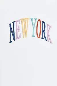 EMBROIDERED TEXT TOP