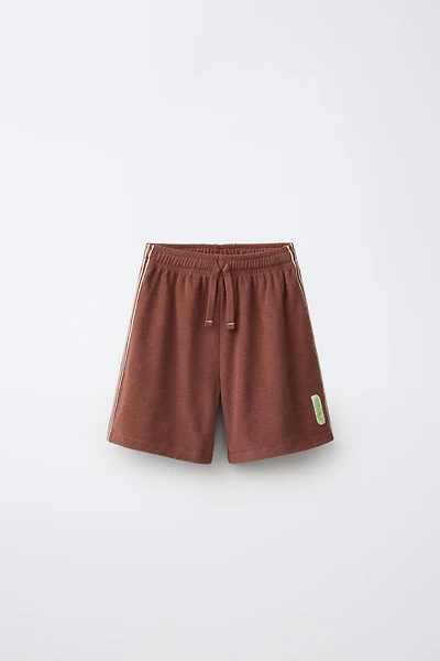 BERMUDA EN TISSU ÉPONGE PUKAS SURF