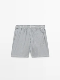 Swimming trunks with striped details