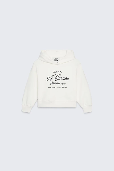 SWEAT À CAPUCHE INSCRIPTION BRODÉE 50TH ANNIVERSARY