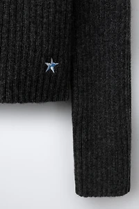 KNIT JUMPER WITH CUT-OUT AND EMBROIDERED STAR