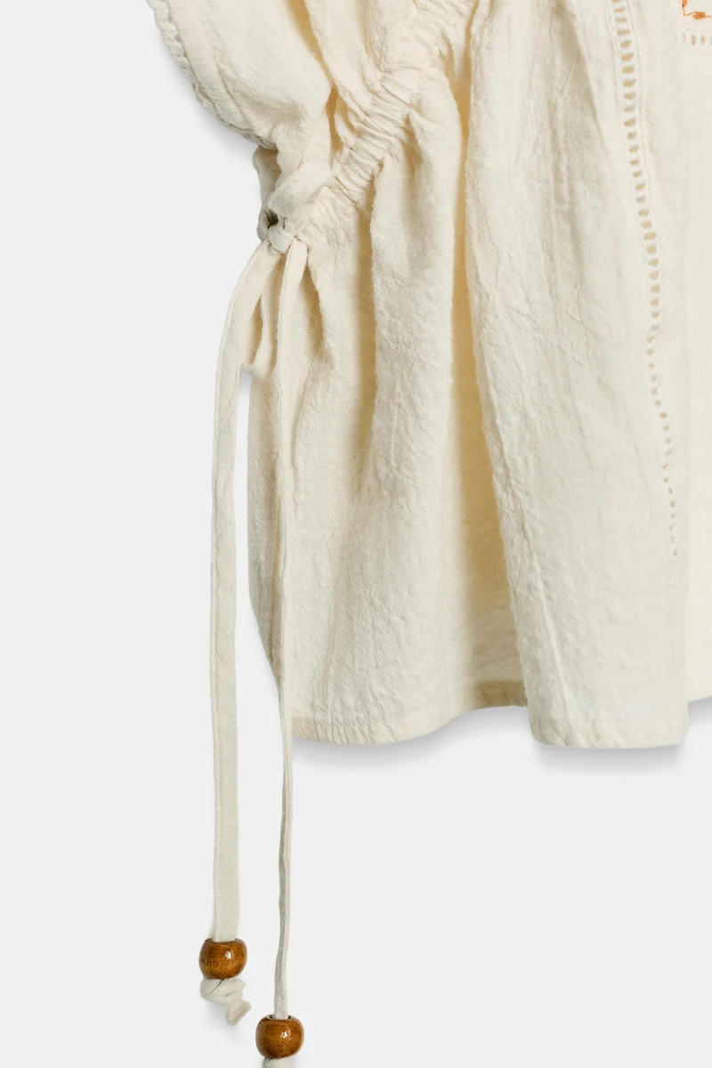 TOP BRODERIES CORDONS LATÉRAUX