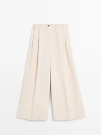 Flowing trousers with turn-up hems