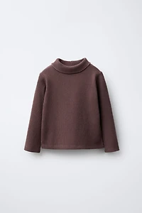 HAUT CÔTELÉ À COL ROULÉ