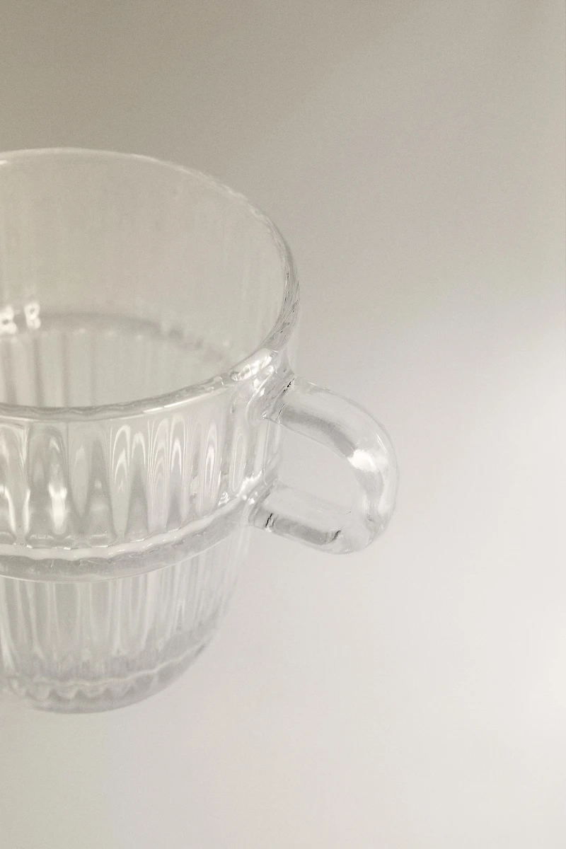 GLASS CUP WITH RAISED DESIGN
