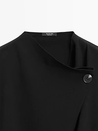 Blouse with crossover detail and button