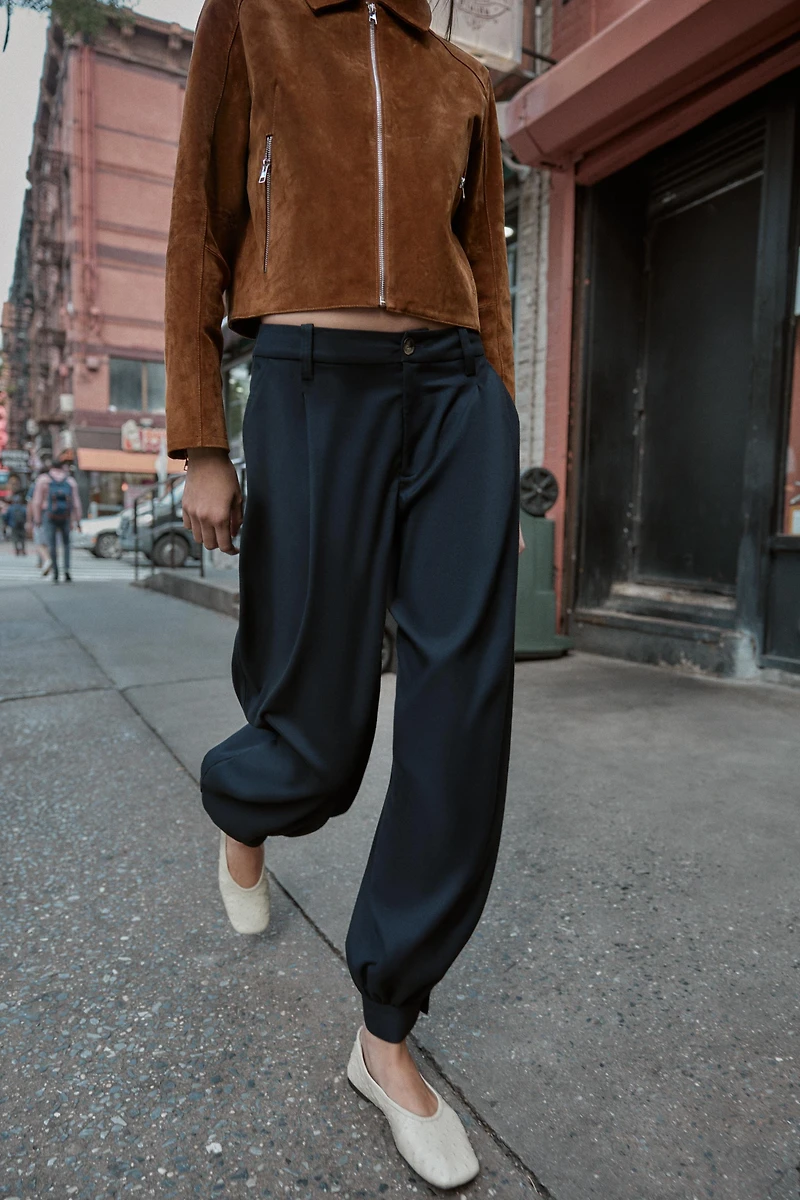 PLEATED PANTS WITH BUTTONED HEM