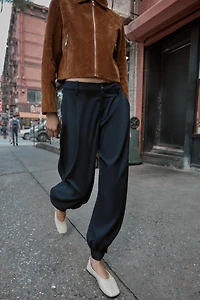 PLEATED PANTS WITH BUTTONED HEM