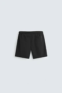 BASIC LONG SWIM TRUNKS