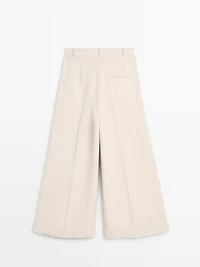 Flowing trousers with turn-up hems