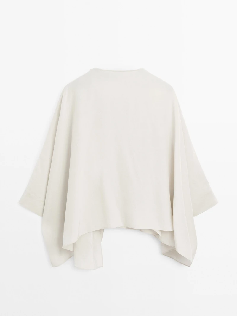 Short flowing cape with sleeve detail