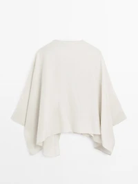 Short flowing cape with sleeve detail
