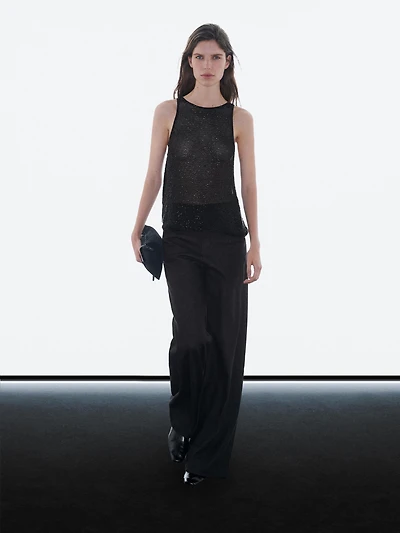 Top semi-transparent à perles fantaisie ton sur