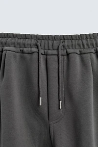 NEOPRENE EFFECT CARGO PANTS WITH PLEATS