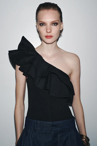 ASYMMETRIC BODYSUIT WITH CONTRASTING RUFFLE