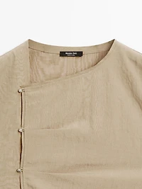 Blouse with silver button fastening on the side