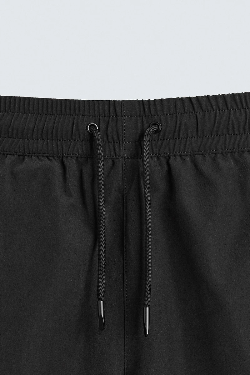 BASIC LONG SWIM TRUNKS