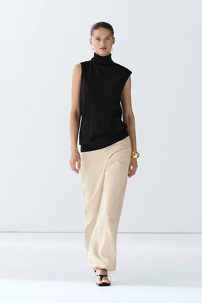 Asymmetric hem turtleneck top
