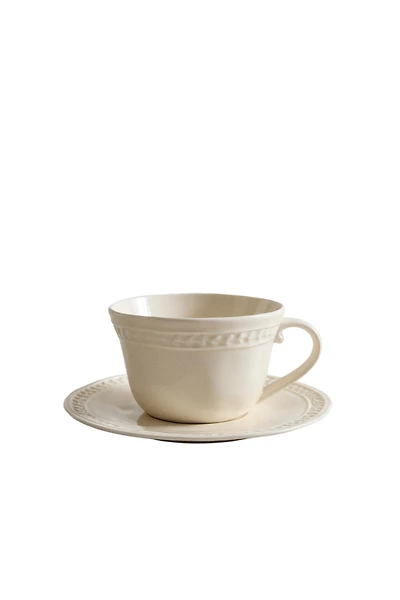 RAISED STONEWARE TEACUP AND SAUCER