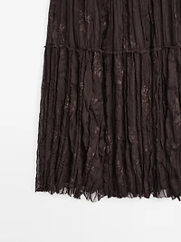 Long pleated skirt with embroidered detail