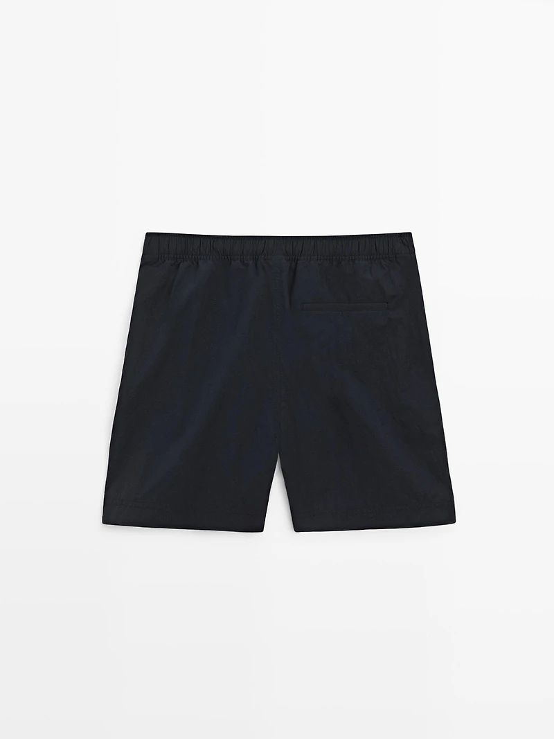 Plain swimming trunks with waist detail