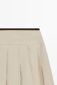 Pleated midi skirt with contrasting sash