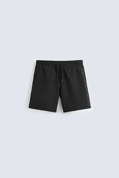 BASIC LONG SWIM TRUNKS