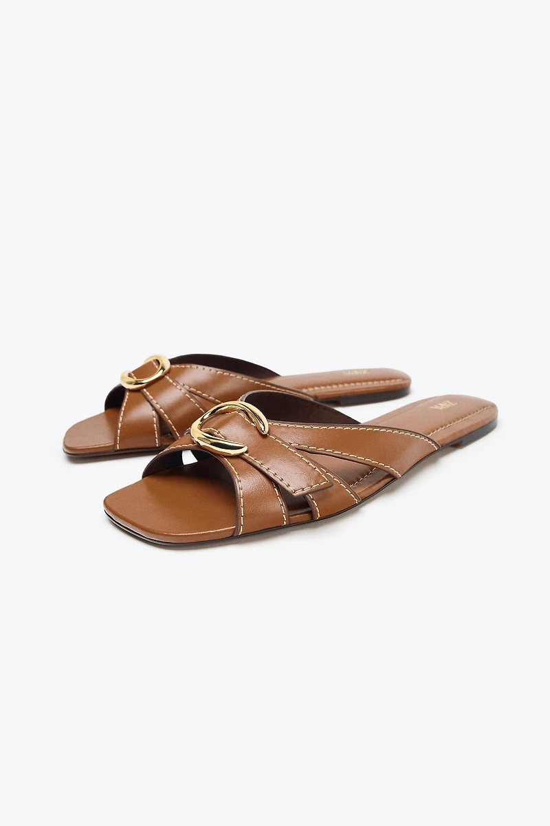 CROSSED SANDALS WITH METALLIC DETAIL