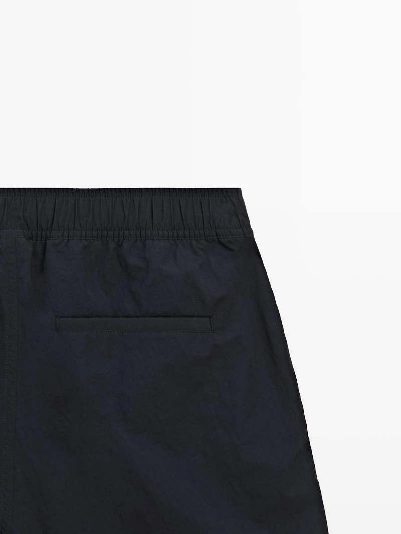 Plain swimming trunks with waist detail