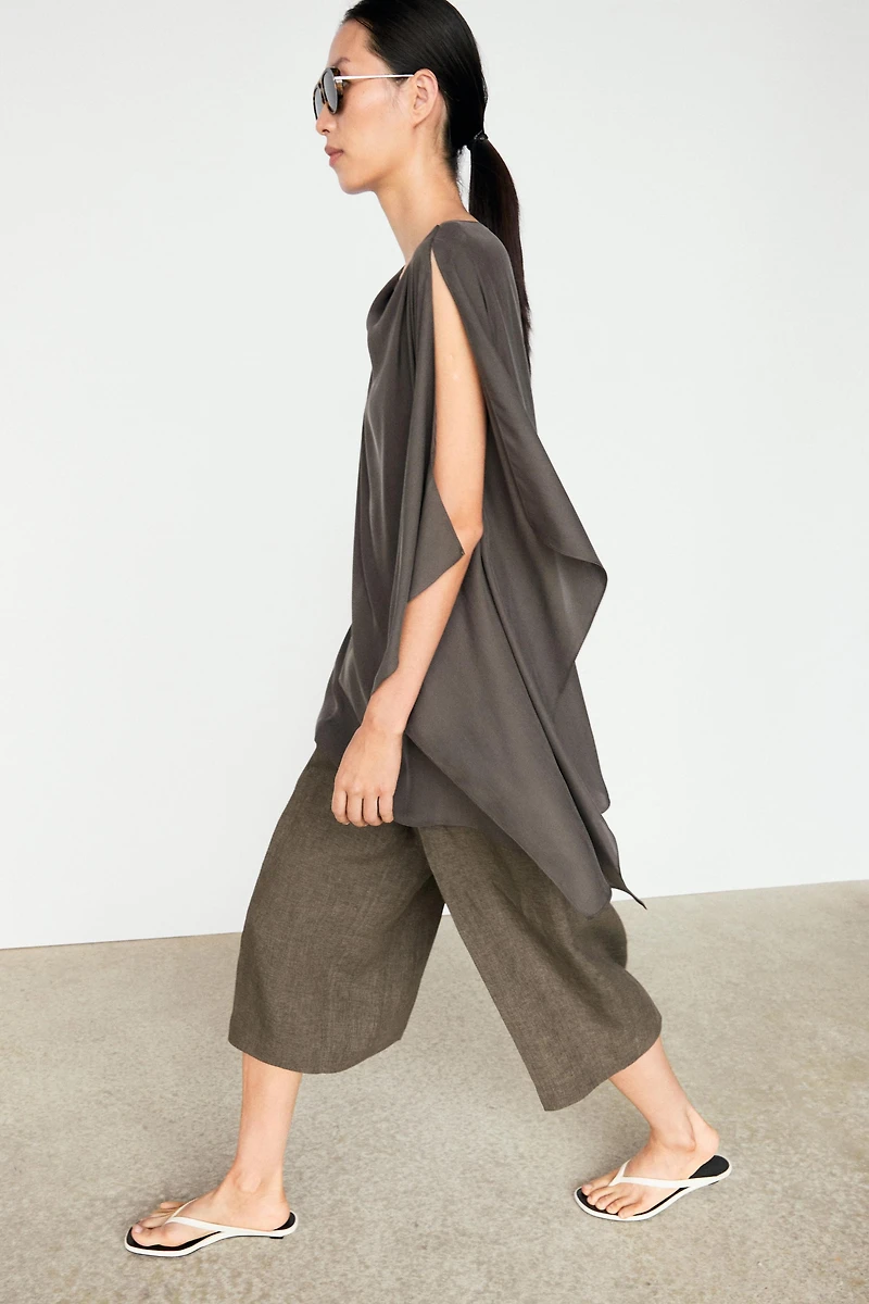 Asymmetric flowing cape top