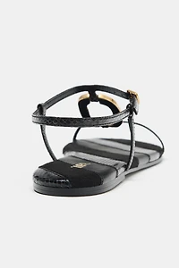 FLAT SANDALS WITH METALLIC APPLIQUÉ