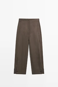 Total look flowing trousers with buttoned hems
