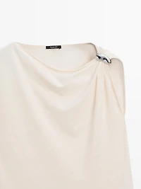 Asymmetric top with shoulder appliqué
