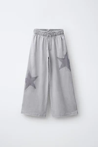 PANTALON LARGE EFFET DÉLAVÉ ÉTOILES