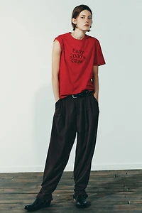 PLEATED PANTS WITH BUTTON HEM
