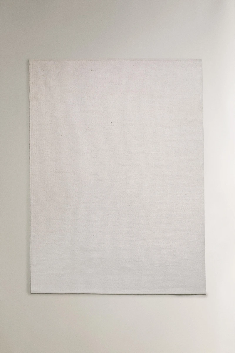 LIGHT-COLORED WOOL AREA RUG