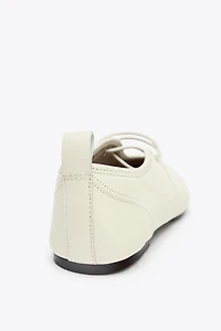 BALLERINES EN CUIR AVEC SURPIQÛRES