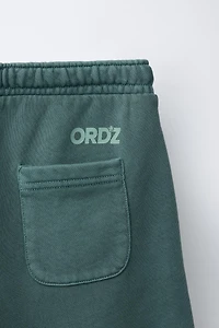 GARMENT DYED LOGO PLUSH SHORTS