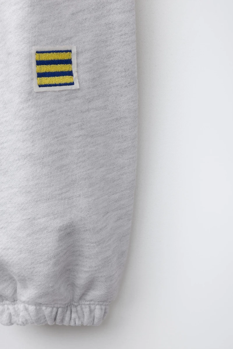 EMBROIDERED FLAG JOGGER PANTS