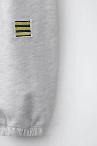EMBROIDERED FLAG JOGGER PANTS
